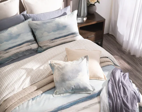 A bed dressed in our Windswept collection with accessories.