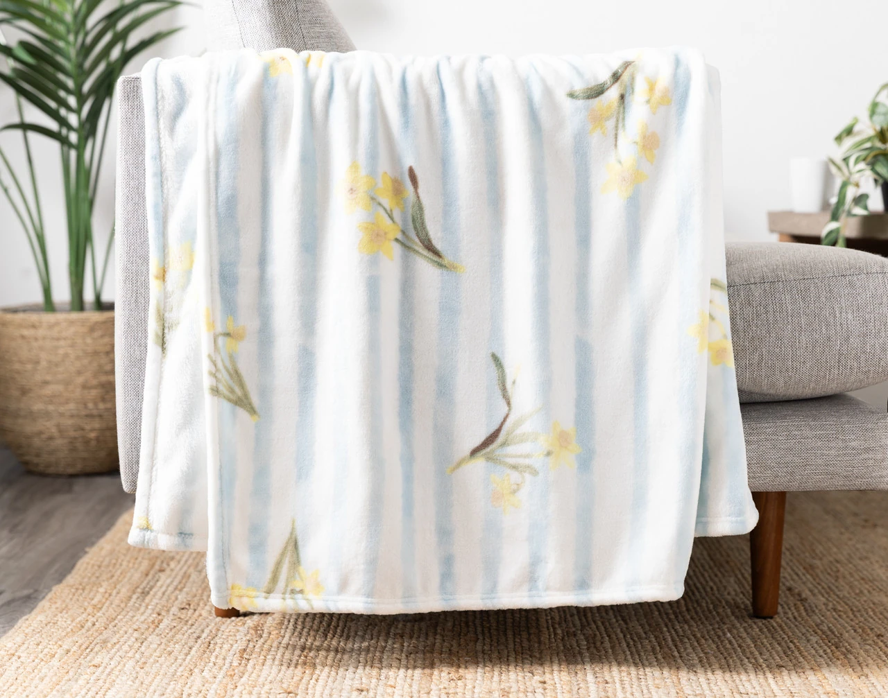 Our Daffodil Easter Fleece Throw draped on a chair.