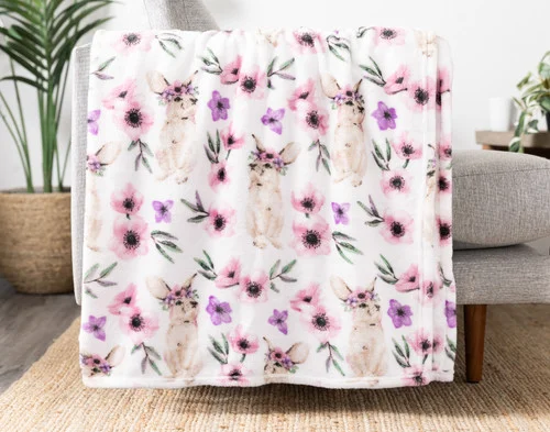 Our Flowers Easter Fleece Throw draped on a chair.