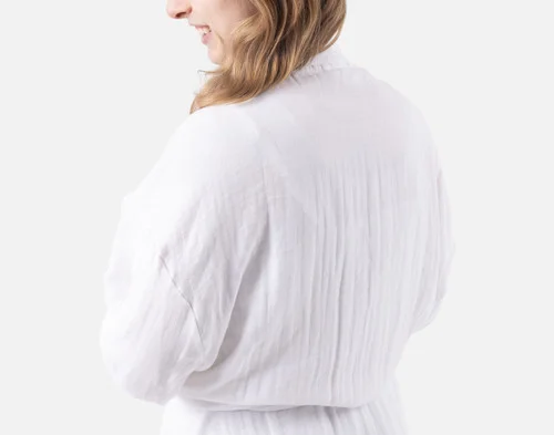 Shoulder view of a woman wearing our Bamboo Cotton Gauze Bathrobe in White.