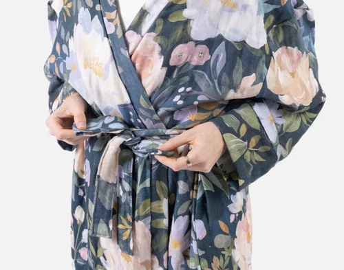 Close-up of two hands tying the belt on our Bamboo Cotton Gauze Bathrobe in Blue Violet.