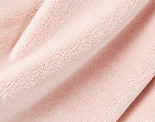 Close-up on our Velvet Plush Throw in Rosewater to show its soft velveteen texture.