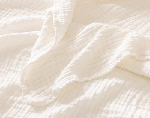 Close up on the textured surface of our Bamboo Gauze Throw in White.