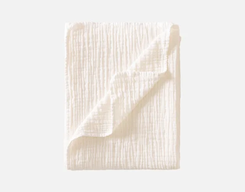 Our Bamboo Gauze Throw in White folded into a rectangle.
