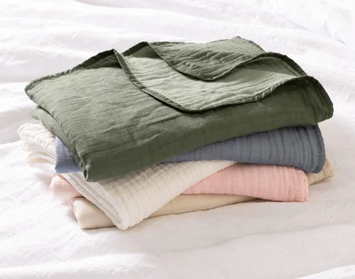 A pile of our Bamboo Gauze Throws in all their colours.
