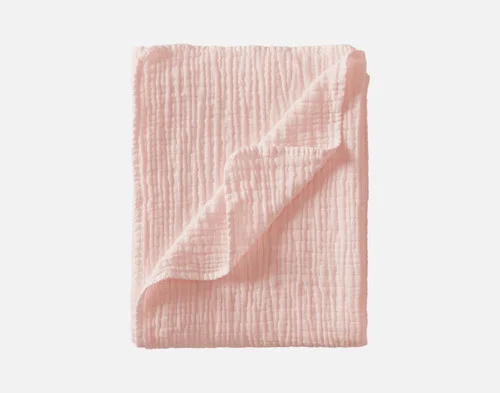 Our Bamboo Gauze Throw in Blossom folded into a rectangle.