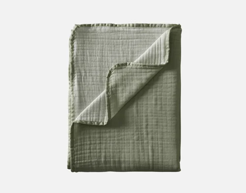 Our Bamboo Gauze Throw in Leaf folded into a rectangle.