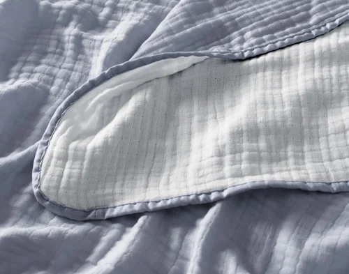 Close up on the textured surface of our Bamboo Gauze Throw in Seaside.