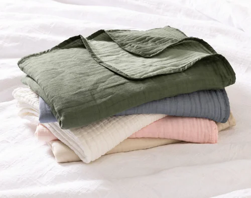 A pile of our Bamboo Gauze Throws in all their colours.
