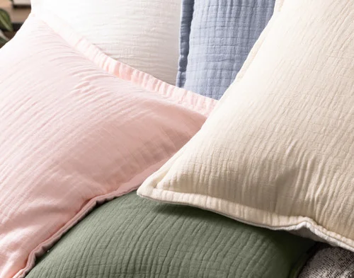 Close up on our Bamboo Gauze Square Cushion Covers in a pile.