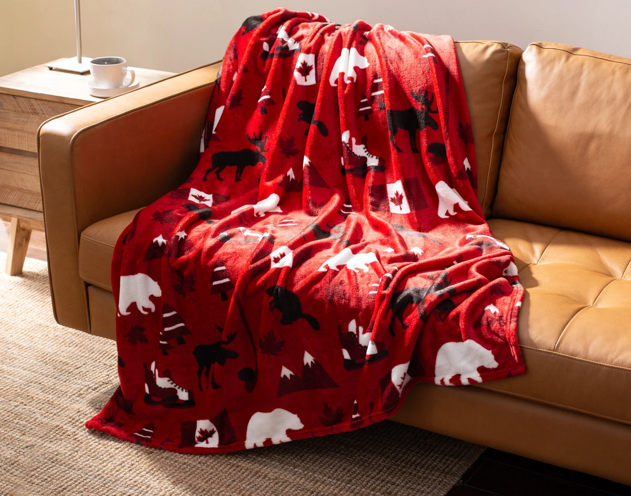 Angled view of our True North Fleece Throw draped gently over a couch.
