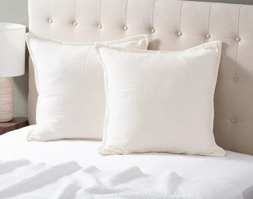 Two of our Bamboo Gauze Euro Shams in White at the head of a bed.