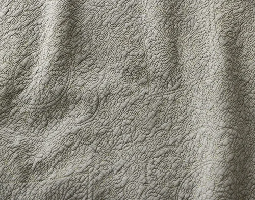 Close-up of the medallion design and sage surface on our Donegal Cotton Quilt Set.