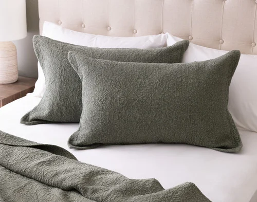 Front view of two pillow shams from our Donegal Cotton Quilt Set resting on a white bed.