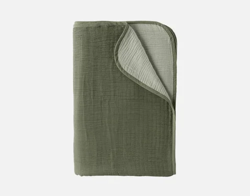 Our Leaf Bamboo Gauze Blanket folded into a neat rectangle over a solid white background.