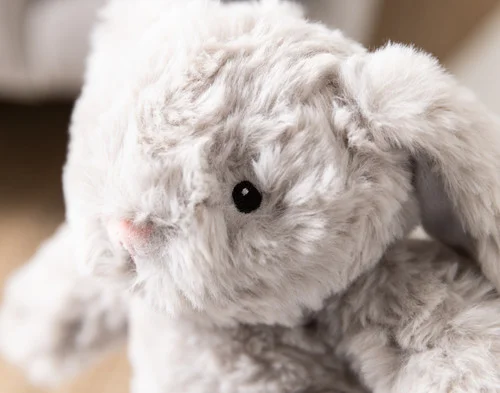 Close-up of the fluffy face of our Small Easter Plush Bunny Cushion.