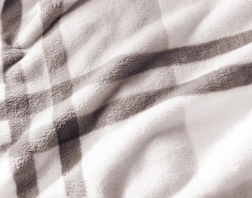 Close-up of the smooth cashmere surface of our Featherstone Plaid Blanket.
