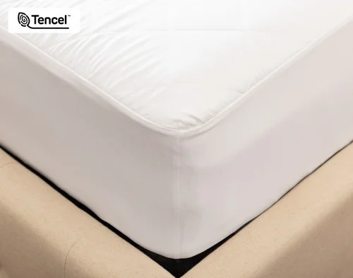 Corner view of our Ambience TENCEL™ Mattress Protector fitted over a mattress.