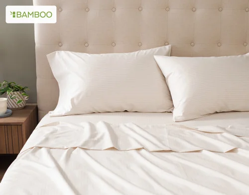 Front view of our Bamboo Cotton Sheet Set in Sandy Stripe dressing a bed in a simple bedroom.