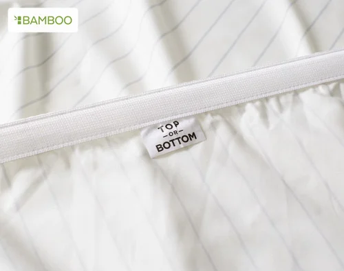 The Top / Bottom tag on our Bamboo Cotton Fitted Sheet in Ocean Stripe.