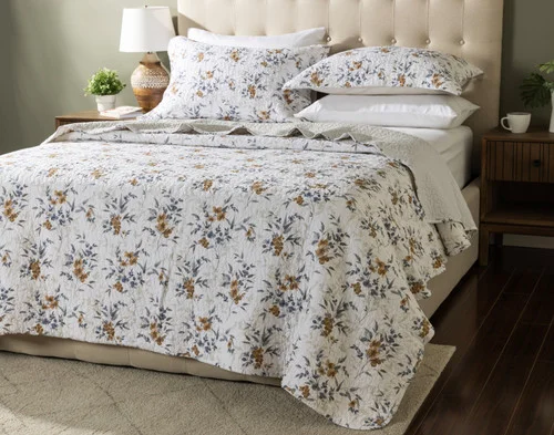 Angled view of our Esther Cotton Quilt Set dressing a queen bed in a modern bedroom.