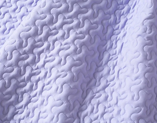Close-up of the solid lilac reverse on our Clara Coverlet Set.