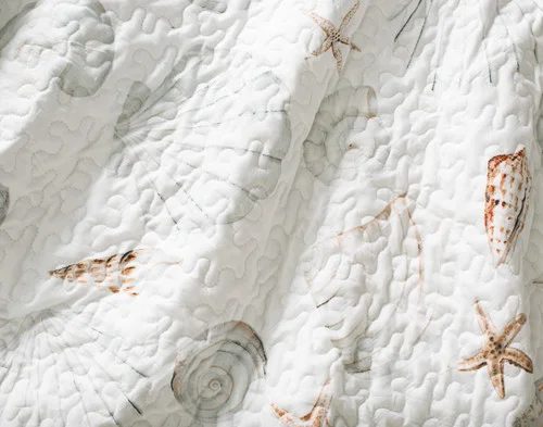 Close-up of the ocean-inspired surface on our Shoreline Coverlet Set.