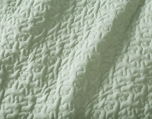 Close-up of the solid green reverse on our Shoreline Coverlet Set.