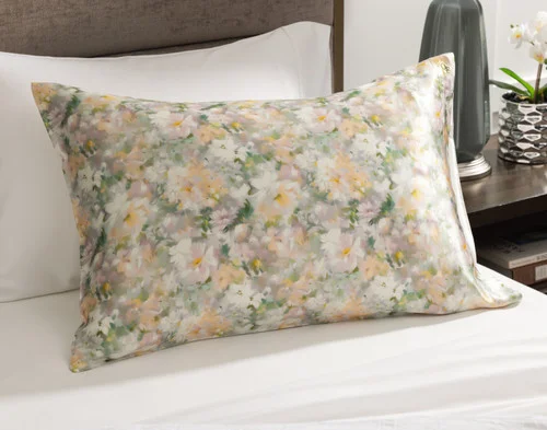 Angled view of our Mulberry Silk Pillowcase in Ruthana sitting on a white bed.