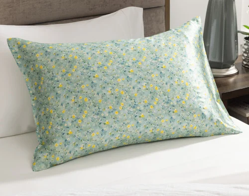 Angled view of our Mulberry Silk Pillowcase in Cadence sitting on a white bed.