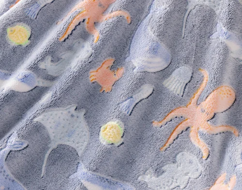 Close-up on the etched designs on our Under the Sea Glow In The Dark Throw.