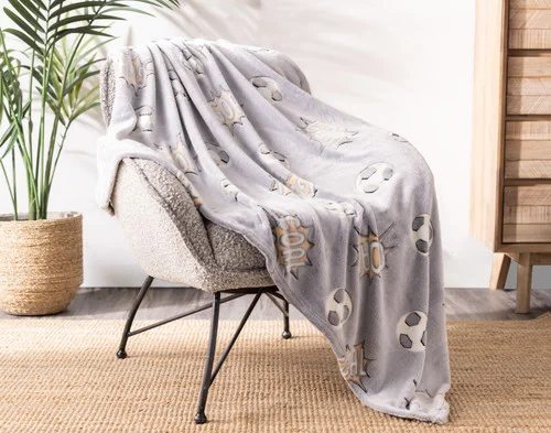 Angled view of our Kickoff Glow In The Dark Throw draped over a chair.