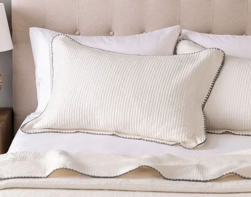 Our Ines Quilt Set Pillow Shams dressing the head of a bed.