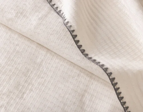 Close up on the folded surface of our Ines Quilt Set.