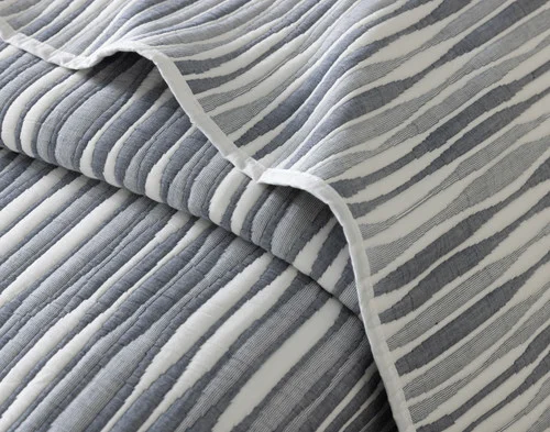 Close-up of the folded edge and tactile wave surface on our Tidemark Quilt Set.