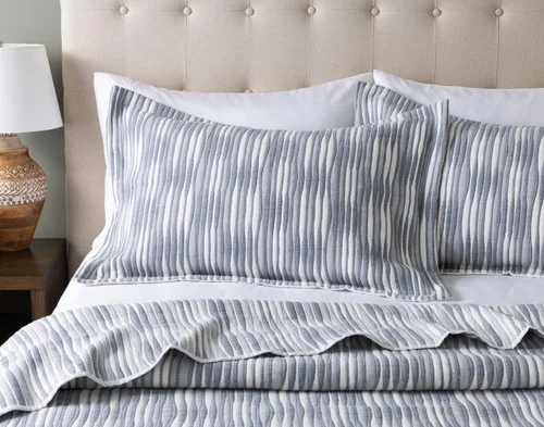 Front view of two pillow shams from our Tidemark Quilt Set resting against a headboard.