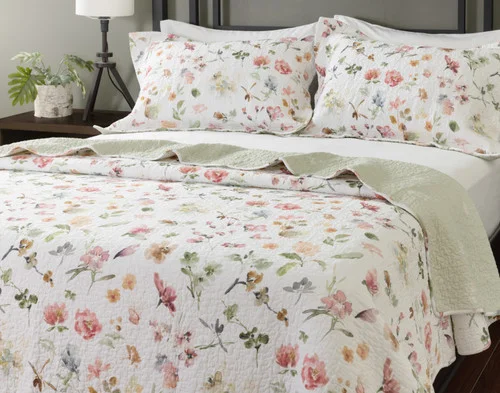 Angled view of our Rosalia Cotton Quilt Set dressed on a queen bed.
