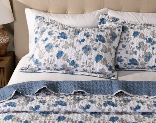 Two pillow shams from our Blaire Coverlet Set sitting on a coordinating bed.