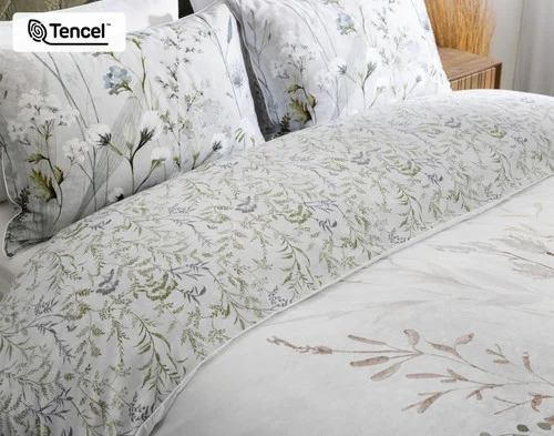 Angled view of the head of a bed dressed in our Greydon collection.