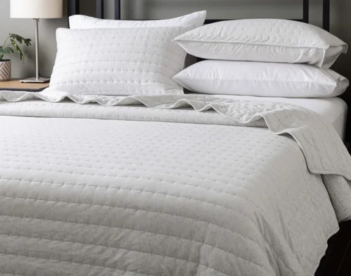 Angled view of our Rove Quilt Set dressing a queen bed.