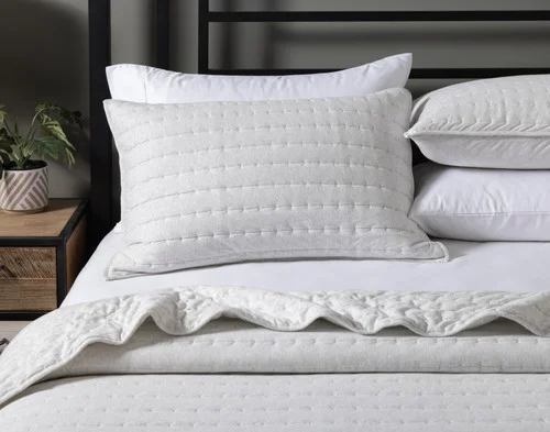 Front, off-centre view of our Rove Quilt Set dressing a queen bed.