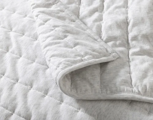 Close view of the folded surface of our Rove Quilt Set.