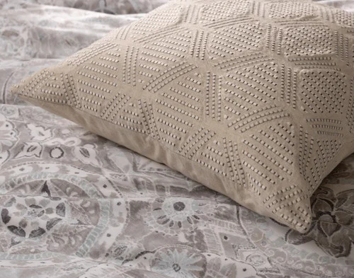 Close up on our Romano Euro Sham atop our Romano Duvet Cover.