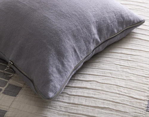 Close up on the corner of our Rocco Square Cushion Cover atop our Rocco Duvet Cover.