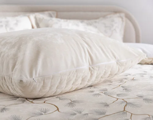 Our Silverbough Euro Sham laying on a bed with our Silverbough collection.