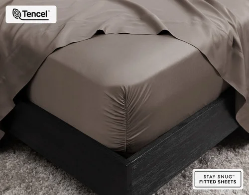 Close-up on the corner of our BeechBliss TENCEL™ Modal Fitted Sheet in Bark fit over a queen mattress.