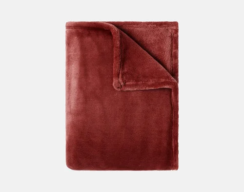 Our Velvet Plush Throw in Redwood folded neatly into a tidy square.