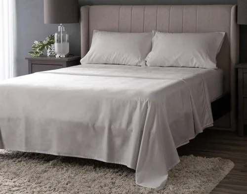 Angled view of our Grey Mist Luxor Egyptian Cotton Sheet Set dressed over a plain queen bed.