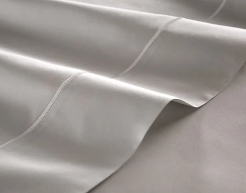 Close-up of the flat sheet of our Grey Mist Luxor Egyptian Cotton Sheet Set fitted over a bed.