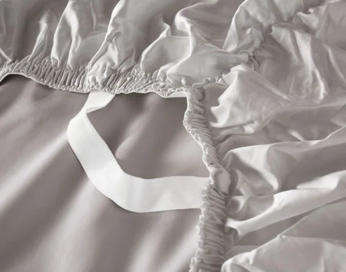 Close-up of the Stay Snug elastics on the loose corner of the fitted sheet for our Grey Mist Luxor Egyptian Cotton Sheet Set.